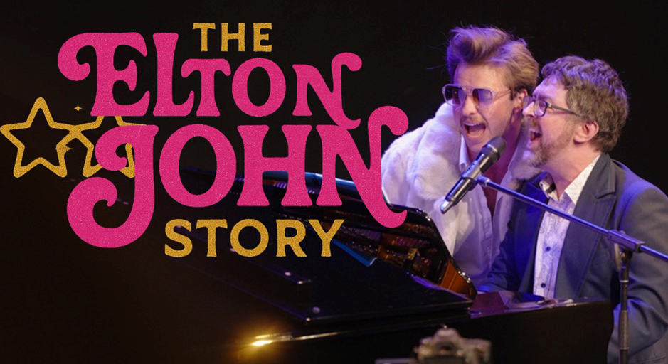 Two men sing at a piano