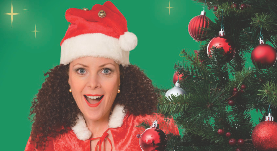 Gina Hogan posing with christmas tree