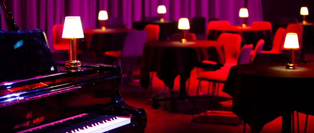 The view from a piano in front of a cabaret setting.