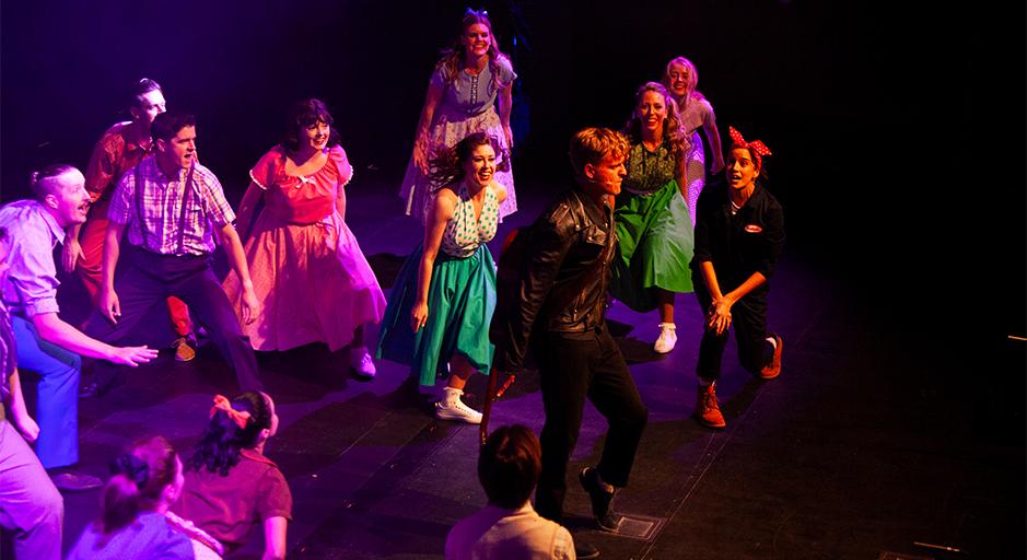 Performers dancing on stage at The Round theatre. 