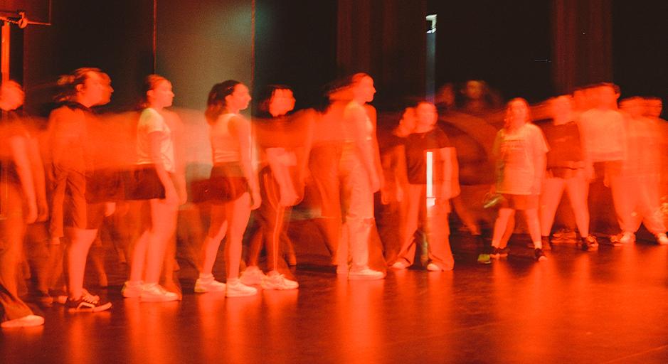 An image captured during a residency at The Round, a slightly abstract image of performers on stage. 