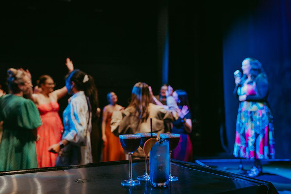 singer performing with people in a crowd dancing