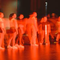 An image captured during a residency at The Round, a slightly abstract image of performers on stage. 