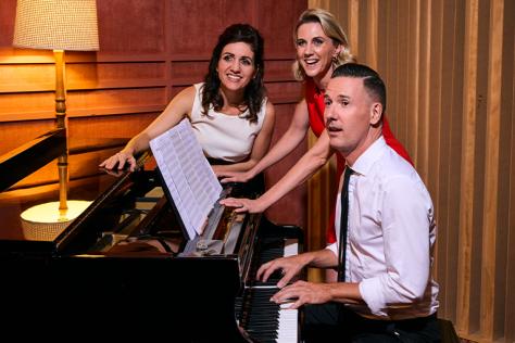 Three performers around a piano