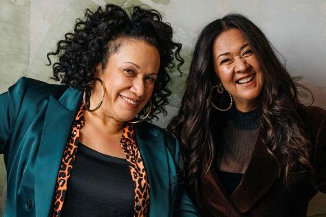 Two women, Vika and Linda Bull, look at the camera with big smiles.