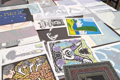 Photograph of a table laid out with artist made prints