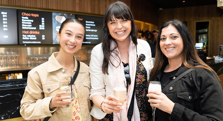 Three women with drinks in The Round bar during Fab Fridays