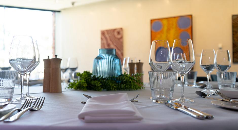 Table setting with cutlery and glassware inside the function space of The Round