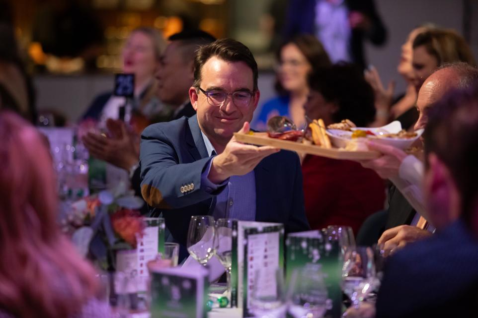 A man is handed a platter.