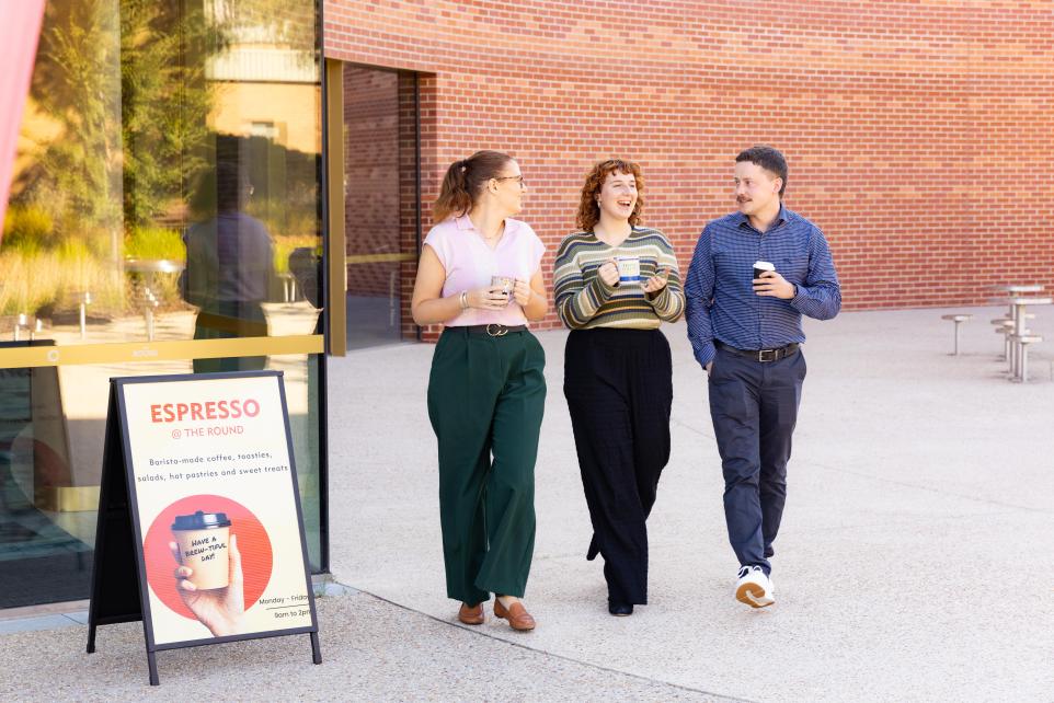 3 people outside with coffeee